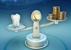 tooth and coins on balance scale